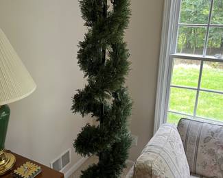 Artificial light-up topiary or Christmas tree.