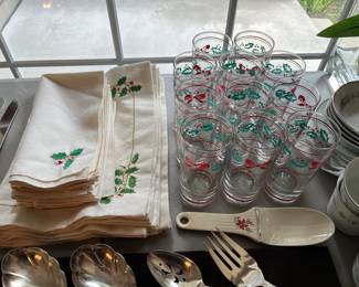 Table linens and glassware with Christmas/holiday theme.