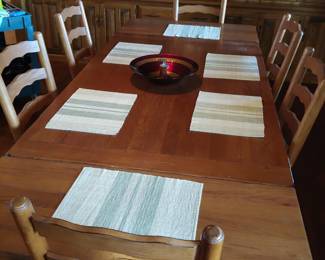 Broyhill dining table with two extensions. Total length with extensions 9 foot.   Includes 2 captain and 4 side chairs with rush seats.  