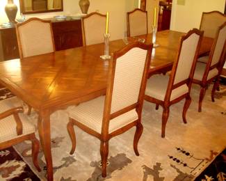 Walnut checkerboard finish dining table with two extension leaves and eight chairs