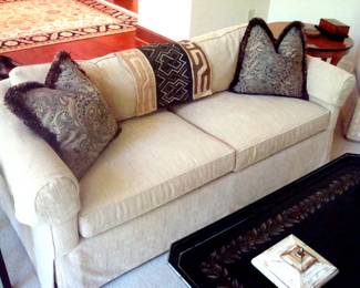 One of three custom upholstered two cushion sofas