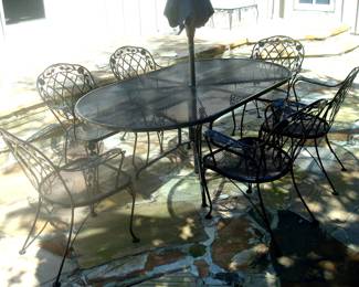 Wrought iron patio table with umbrella and six chairs. (chairs have cushions in excellent condition)