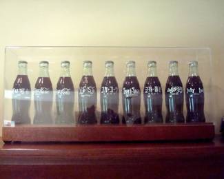Coke bottles from around the world in case.