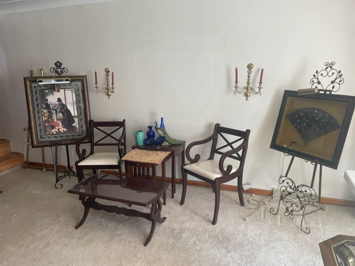 framed art, mahogany furniture and several easels throughout the home