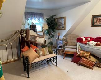 queen size brass headboard, black wrought iron bench glider rocker and ottoman floor lamp deco pillows towels linens