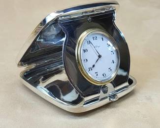 Gorham Sterling Silver Travel Clock, 8-day 15-jewel Concord movement.  $400   The heavy sterling case and strut facade are products of Gorham Mfg. Co., highly regarded Providence, Rhode Island silversmiths.  The firm's distinctive hallmark is stamped next to sterling on the interior left lip of the case shell.  The shaped right lip carries the model number and Gorham silver date cypher (scimitar), designating 1917 as year of production.   Among noteworthy features of this (pre-automobile, pre-household electricity) travel clock:
premier quality thick gauge sterling case with precision hinges, perfect shell alignment and crisp push-button closure
cushion shape - front machined with pinstripes and hand engraved with elaborate monogram in diamond reserve 
nearly pristine condition - absent significant dents or deep scratches
flawless fired enamel dial under beveled crystal - bold numbers for reading by candlelight
delicate cut and blued spade and whip hands  
shaped sterling silver strut