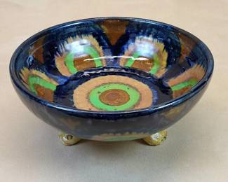 Important c. 1900 Vienna Secessionist art pottery 8" bowl with dramatic enamel decor.    $195     The short-lived Vienna Secession (and Jugendstil) Movement was a radical departure from typically conservative German designs in architecture, fine and decorative arts.  Ceramics represented only a small portion of Secessionist household objects.  Few unique Jugendstil art pottery pieces of particular merit survived 125 years.

The form of this thick-walled fruit bowl is unremarkable and the foot treatment rather awkward.  However, all that is commonplace disappears on viewing cobalt blue, green, medium and pale brown enamel painted decoration.  Bold "flaming beehives" spaced between cavetto triangles transcend eye-catching.

In fine condition, absent breaks, cracks or repairs.  Chips at two foot terminals are aesthetically inconsequential.  A qualified ceramics restorer would encounter little difficulty filling and inpainting losses.               

3.25" high x 8" diameter