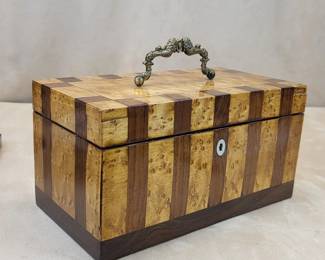 PREMIER BIRD'S-EYE MAPLE & ROSEWOOD TWO-COMPARTMENT TEA CADDY $350   FINE ORIGINAL CONDITION!   4.7"  high less handle, 9.1" wide, 4.75" deep

A large handsome circa 1840 box benchcrafted of exotic veneers; displaying superb design, craftsmanship, detail and finishing. 

Particularly fine attributes include:


gilt-bronze bail handle cast as cornucopia centering an oval florette

wide rosewood banded bird's-eye maple veneers with rosewood base

inlaid nacre escutcheon

functional lock with key

fully veneered interior case tops and cover

largely intact tin linings

original baize bottom

satin-rubbed French polish