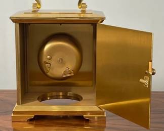 Bell cover of movement accessed for winding and setting through rear door.