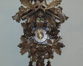 Anton Schneider Black Forest 8-day musical cuckoo clock.  Fine Operating Order.  $615   Eight-day (vs. 30-hour running) cuckoos represent not more than 10% of total Black Forest production.  Those with music box / turntable dancers are an even smaller subset.

Anton Schneider ranked among premier manufacturers active during the third and fourth quarters of the 20th century.  Their carved cases, dials, hands and cuckoo birds are solely wood (vs. plastic and resin).  Reuge is widely regarded as the best Swiss manufacturer of music boxes.  The two tune 50-note box in this clock is far superior (acoustically and complexity) and more costly than generic music boxes installed in 30-hour cuckoos and most 8-day models. 
I acquired this clock in original German shipping carton from a relative of the original owner.  The Schneider cuckoo was purchased in Germany in 1992.  Critical examination suggests the clock was little used.

    
A seemingly identical Anton Schneider 8-day musical cuckoo is 