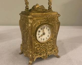 Exceptionally Rare Circa 1900 French Rococo Revival Miniature Gilt-Bronze Carriage Clock.  High grade eight-day gong-striking movement with push-button repeat of the previous hour.   Delicate fired ivory enamel dial with Arabic numbers and gilt minute indicies.  Pierced gilt metal hands.  Beveled glass crystal.  Original throughout and operating order.  $1,825  