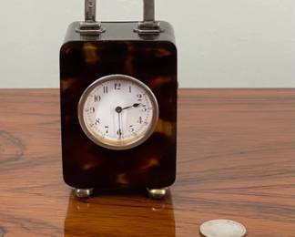 Sub-miniature tortoiseshell and sterling silver carriage clock hallmarked London 1929.  Slight damage at base of case.  Otherwise fine and operating order.  $750  