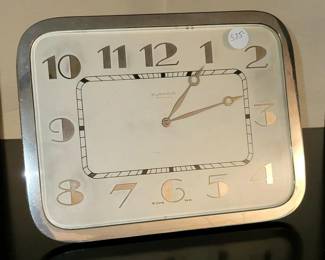 Oversize Swiss Art Deco mantle / table clock with heavy nickeled brass bezel, backing and strut.  Satin silvered dial with bold applied numbers carrying the Canadian merchant's name above "Lever 15 Jewels."  High grade 8-day movement.  Fine overall condition and operating order.  9.5" wide x 7" high  $575 firm 