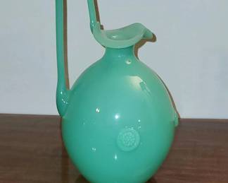 Circa 1910 ewer form freeblown art glass vase of vibrant Uranium green color.  Attributed to Stevens & Williams.  Tall angular handle, petal shape mouth, ovoid body with three beaded ring roundels.  Perfect. $86
