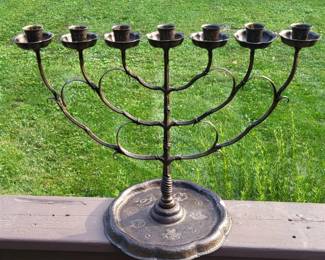 Remarkable antique German oversize wrought and cast iron menorah with bronze patina.  $345   Delicate scrolls applied to branch arms, tooled nozzles, floriform bobeche, large piecrust rim base stamped with stylized floral motifs in a line and star border.  Underside of base stamped "GERMANY" along with maker's monogram (conjoined F W).  Circa first quarter 20th century or slightly later.  13.5" high, 18.5" wide, 9.25" diameter base  3.4 lbs. 