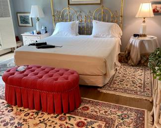 Brass King bed and hand-woven rugs.