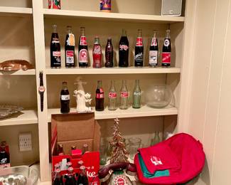 Coca-Cola memorabilia, vintage bottles, telephone, backpack.