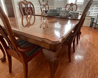 Beautiful dining room table with extra leaf and mat.  It has six matching chairs.