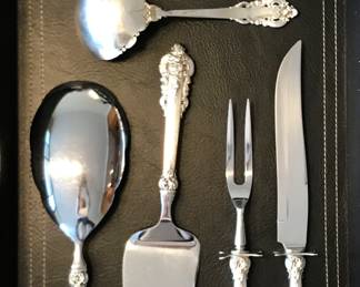 Wallace Grand Baroque 
sterling serving pieces from set:
Wallace Grand Baroque sterling flatware-30 soup/24 dinner forks/40 salad forks/16 butter spreaders/22 teaspoons/26 dinner knives/7 serving pieces. 
$8000