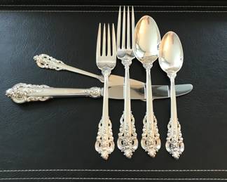 Wallace Grand Baroque
sterling place setting from set:
30 soup/24 dinner forks/40 salad forks/16 butter spreaders/22 teaspoons/26 dinner knives/7 serving pieces. 
$8000