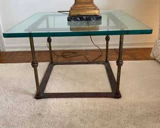 One of a pair of vintage, but very current brass and glass end tables. The need a polish.