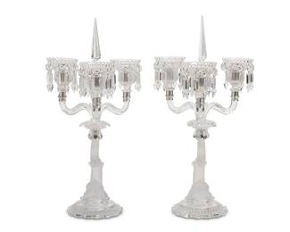 1002
20th Century
A Pair Of Baccarat Molded And Cut Glass Candelabra
Each marked for Baccarat
Each four-light, lead glass candelabrum in molded frosted glass and cut clear glass, with a Classical style dolphin column issuing three scrolled arms and a central arm with removable prisms, 2 pieces
Each: 18.75" H x 12.5" Dia.
Estimate: $1,500 - $2,000