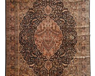 1018
21st century
A Pakistani Area Rug
The washed wool and silk on cotton foundation rug with foliate motifs in earth tones surrounding a central medallion on a dark navy blue ground
11' 9" L x 9' 2" W
Estimate: $800 - $1,200