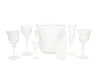 1032
Late 20th century
A Group Of St Louis "Tommy" Crystal Stemware
Most marked: St Louis / Cristal / France
The lead glass stemware decorated with diamond, bevel, and pearl cuts and a starburst base, comprising 11 fluted champagne glasses (8.125"), 12 burgundy wine glasses (6.75"), 11 continental goblets (7.125"), 5 water goblets (7.75"), 4 cordial glasses (4.25"), 1 highball glass (5.5"), and 1 champagne bucket (8.125" H x 9" Dia.), 45 pieces
Estimate: $800 - $1,200