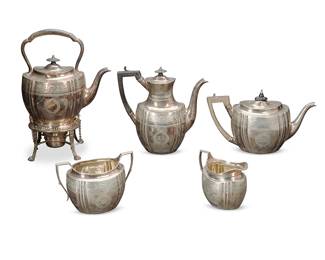 1051
Late 19th/early 20th century
A Victorian English Sterling Silver Tea And Coffee Service
Each marked with English hallmarks for London; maker's mark for William & George Sissons; tipping kettle and creamer with British registration marks
Each with chased foliate banding and wreaths, the kettles with carved wood handles, comprising a hot water tipping kettle with silver-plated burner and stand (13.25"), a coffee pot (8.875"), a teapot (6"), a sugar bowl (4.375"), and a creamer (4"), 5 pieces
82.57 gross oz. troy approximately
Estimate: $2,000 - $3,000