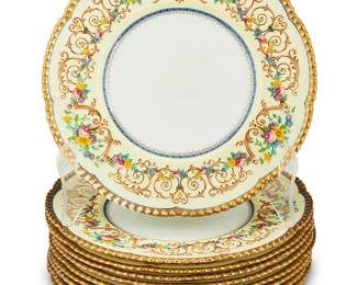 1055
Early/mid-20th century; Knottingley, Yorkshire, England
A Set Of Royal Cauldon Porcelain Dinner Plates
Each marked: Cauldon China / England / Est 1774
Each with polychrome floral and scrollwork decoration to the rim and scalloped gold edge, 10 pieces
Each: 10.25" Dia.
Estimate: $500 - $700