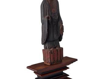1069
18th century or later
A Korean Carved Wood Buddha Statue
The carved and polychromed wood sculpture of a deity, together with a contemporary wood stand, 2 pieces
Without base: 18.5" H x 5" W x 3.5" D; base: 6" H x 11.75" W x 4.325" D
Estimate: $500 - $700