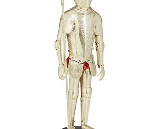 1100
20th century
A Continental Metal Miniature Suit Of Armor
Appears unmarked
The highly detailed, multi-piece miniature suit of armor with chased designs throughout accented by a terracotta thread fringe to the waist, set upon a painted wood stand
12.25" H x 4" W x 3" D
Estimate: $500 - $700