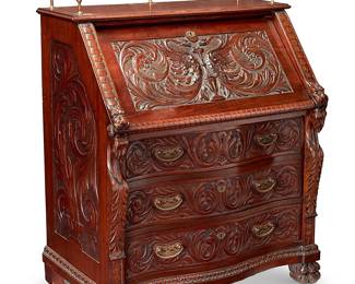 1108
Late 19th/early 20th century; New York, NY
An R.J. Horner "Governor Winthrop" Desk
Metal tag to interior of top drawer: R.J. Horner & Co. / Furniture Makers / [address]
The Chippendale-style mahogany slant-front desk with brass hardware profusely decorated with allover carved acanthus leaf and scrolled motifs, highlighted by two opposed dragon heads to the sides and the slant front featuring carved dragons centering a water basin, which opens to reveal four letter slots and a pullout drawer to each side, centering a lockable document compartment, all above three oxbow and machine dove tailed drawers, set on lion paw feet to front and square feet to back, and surmounted by a brass gallery rail
44.5" H x 36.5" W x 24" D
Estimate: $1,000 - $2,000