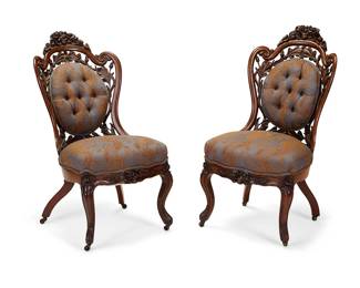 1110
Mid-19th century
A Pair Of Rococo Revival Carved Openwork Parlor Chairs
Each appears unmarked
The two walnut parlor chairs decorated with carved and openwork roses, acorns, and foliate motifs; the seat cushion and tufted oval back cushion upholstered in blue and gold foliate pattern, set upon carved cabriole legs with acanthus leaf feet on casters
Each: 36.25" H x 18.75" W x 26.75" D
Estimate: $1,000 - $2,000