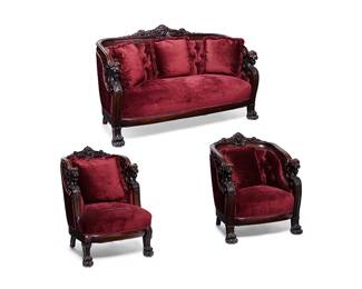 1119
Late 19th/early 20th century
A R.J. Horner-Style Parlor Set
Metal tag to lower back of short-armed chair: Levin Bros. Inc. / Guaranteed Upholstered Furniture / Minneapolis, Minn.
The walnut carved wood parlor set comprising a sofa and two chairs featuring ornately carved griffin heads to the backrest, sculptural griffin head armrests cresting carved wing supports, set upon four legs, the front two griffin paw feet; upholstered in burgundy velvet and sold together with five conformingly upholstered square pillows with brushed fringe trim, 8 pieces
Sofa: 40.625" H x 66.5" W x 29.25" D; each chair: 39.75" H x 32.5" W x 31.5" D approx.
Estimate: $1,500 - $2,500