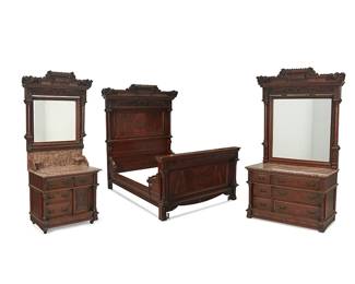 1122
Late 19th/early 20th century
A Renaissance Revival Bedroom Set
Appears unmarked
Comprising a carved and burl walnut queen-sized bedframe, six-drawer dresser with pillared front, surmounted by a red marble top and ornately carved framed mirror, set upon four squared legs, and washstand with four drawers and one cabinet, surmounted by a red marble top and framed mirror, set upon four metal casters, each piece conformingly designed, 8 pieces
Largest: 79" H x 62" W x 81.5" D; smallest: 84" H x 40" W x 21.5" D
Estimate: $1,000 - $2,000