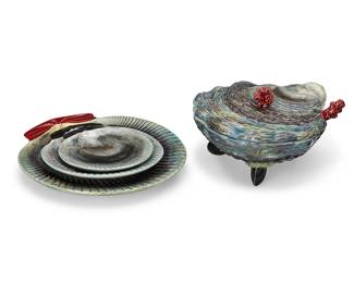 1128
Mid-20th century
A Bordallo Pinheiro Majolica Shellfish Dinner Service
Each faintly impressed to underside: Made in Portugal / [illegible]; some with stamp: Bordallo Pinheiro C. Rainha; some with sticker: Made in Portugal
The Portuguese Palissy ware set comprising 14 dinner plates (11.325" Dia.), 3 salad plates (8.125" Dia.), 5 bread and butter plates 6.625" Dia.), and 2 lidded tureens (5.25" H x 9.5" Dia.) with serving spoons (8" L), 24 pieces
Estimate: $500 - $700