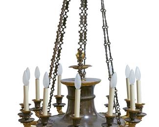 1142
Mid-19th century
A French Louis Philippe Chandelier
The twelve-light gilt and patinated bronze chandelier with foliate arms and faux candles, circling a scrollwork and foliate central medallion with a columnar form surmounted by an eternal flame finial, suspended by six cast foliate chains from an architectural cornice plate, electrified
36" H x 25.5" Dia.
Estimate: $5,000 - $7,000