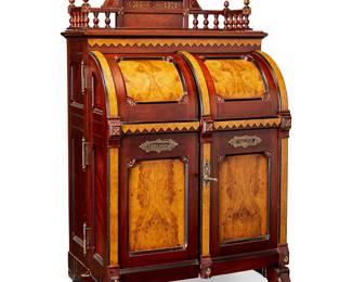 1150
Late 19th/early 20th century; Indianapolis, Indiana
A Wooten Desk Co. Walnut And Burl Maple Cabinet Secretary
Marked to brass plaque on the righthand door front: Manufactured by Wooton Desk Mnf. Co. / Indianapolis, Ind. / W.S. Wooten's Patent / Oct 6 1874
The Rennaissance Revival office secretary with a walnut and burl maple carcass accented with gold leafed carving, with hinged, arched double doors, secured with a cast brass locking turn handle mechanism, opening to reveal a drop-front writing surface inset with gilt stamped black leather, the right interior door with one-hundred and ten pigeonholes, each with a green cardboard drawer, as well as variously sized cubby holes and drawers throughout the interior; all surmounted by a carved and gilt spindle gallery rail and set upon four metal casters
76" H x 42.25" W x 26" D
Estimate: $5,000 - $7,000