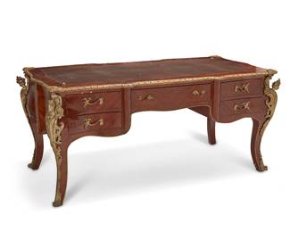 1160
20th century
A Louis XV-Style Bureau Plat
The book match veneered wood desk with gilt-bronze mounts and inset gilt-stamped leather writing surface over one center drawer and four small drawers
32" H x 71.5" W x 36" D
Estimate: $400 - $600