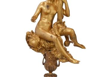 1159
Late 19th/early 20th century
A Beaux Arts-Style Figural Torchère
Appears unmarked
The gilt bronze depicting a female figure seated atop a pedestal base, decorated with Neoclassical-style motifs including acanthus leaves, fleur-de-lis, and lion masks, surmounted by a single light with a frosted globe shade, and set upon three paw-form feet, electrified
70" H x 26" W x 21" D
Estimate: $2,000 - $3,000