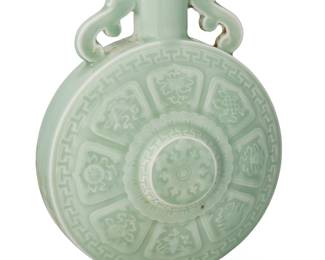 1177
20th century
A Chinese Celadon Glazed Porcelain Moon Flask
Marked to the underside in blue underglaze bearing an apocryphal reign mark for Qianlong Period (1736-1795)
With impressed Bajixiang designs to verso and recto and opposing scrollwork handles to the neck
10.5" H x 7" W x 3.5" D
Estimate: $500 - $700