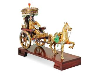 1183
Mid-20th century
A Chinese Enameled Brass Sculpture Of A Horse And Carriage
Appears unmarked
The cast brass and carved wood sculpture of a horse drawn carriage with a female rider, heavily embellished with polychrome enamel, faux carnelian and jade cabochons, brass chain, and freshwater baroque pearls, on a carved wood plinth base
12.5" H x 14.5" W x 5.75" D
Estimate: $700 - $900