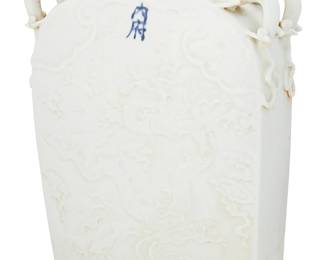 1189
20th century
A Chinese Yuan-Style Porcelain Flask Vase
Marked to the body in blue underglaze bearing an apocryphal imperial mark
The squared flask-form vase with impressed decoration to each side depicting a dragon amongst the clouds and dual opposing applied dragon handles to each of the shoulders
15.5" H x 12" W x 3.75" D
Estimate: $600 - $800