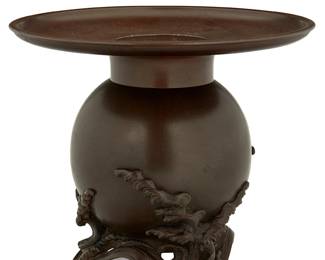 1196
Meiji Period 1868-1912 or later
A Japanese Usubata Bronze Ikebana Vase
Stamped to the underside with Japanese characters (possibly reading): Kamehisa
The cast bronze vessel with a wide ledge/lip encircling the inset basin within the globular stand with high relief undulating bonsai decoration
10.25" H x 11.75" Dia.
Estimate: $500 - $700