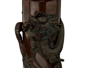 1198
Meiji Period 1868-1912 or later, circa 1905-1915
A Japanese Bronze Dragon Vase
Embossed to the underside with six-character mark (possibly reading): Dai Nihon Osaka [Shima]sada Seizo
The cylindrical cast bronze vase encircled by a raised relief dragon rendered in precise detail and meandering motif encircling the rim
12" H x 5.5" Dia.
Estimate: $1,000 - $1,500