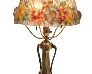 1203
Circa 1910s; New Bedford, MA
A Pairpoint Reverse-Painted Puffy Glass "Stratford" Table Lamp
Stamped to the glass shade in gilt: The Pairpoint Corp./ Patented July 9, 1907; base appears unmarked
The three-light table lamp with a "Stratford" glass shade depicting hummingbirds and roses, set upon a possibly later added brass base with three applied cast metal foliate accents, electrified
21.5" H x 13.75" Dia.
Estimate: $2,000 - $3,000