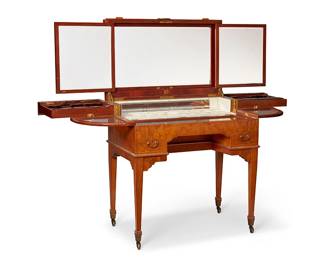 1215
Late 19th/early 20th century
A George Betjemann & Sons Inlaid Mahogany Dressing Table
With a plaque to the interior front edge: Boyes, Bassett & Co., Shanghai; further marked with a second plaque: Rd No 541493
Retailed by Boyes, Bassett & Co., Shanghai, the fold-out poudreuse with book-matched mahogany veneer to the exterior, hinged lid opening to reveal a tryptic mirror, numerous inset cubbies in lacquered ivory wood for manicure pieces such as vanity jars, brushes, combs and hand mirrors, various leather-lined compartments to the interior fore beneath a glazed hinged lid, a hidden drawer behind, two beveled glass fold-out extensions, and two locking drawers to the exterior on either side; set upon four marlborough tapered legs, each with a brass end cap and caster
38.5" H x 35" W x 22" D
Estimate: $500 - $700