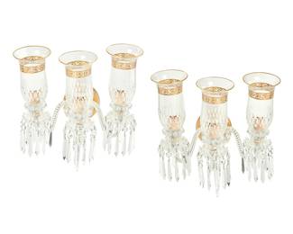 1217
20th century
A Pair Of St. Louis Gilt Glass "Thistle" Wall Sconces
Each three-light sconce with faux candle fixtures on molded glass bases with draping prismatic tear drops and glass shades with banded gilt acanthus leaf scrolls, mounted on three rope spiral glass arms radiating from the gold metal wall mount with prismatic and molded glass accents, electrified, 2 pieces
Each: 20" H x 15.5" W x 15" D
Estimate: $1,000 - $2,000