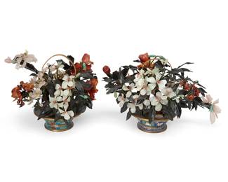 1222
Mid/late 20th century
Two Chinese Carved Stone Trees
Each unmarked
The trees decorated with carved quartz and various other hardstone peony flowers and possibly nephrite leaves, affixed to woven fabric-encased and pliable "branches," stemming from a painted plaster trunk, set in a weighted brass and enamel cloisonné pot with foliate motif on a blue ground and a brass "basket" handle, 2 pieces
Each: 11.5" H x 18" W x 11" D approx., dimensions variable
Estimate: $600 - $800